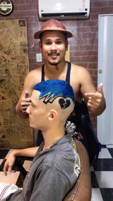 Cliente com cabelo azul e desenho na lateral, atendido na Rota 22 Barbershop
